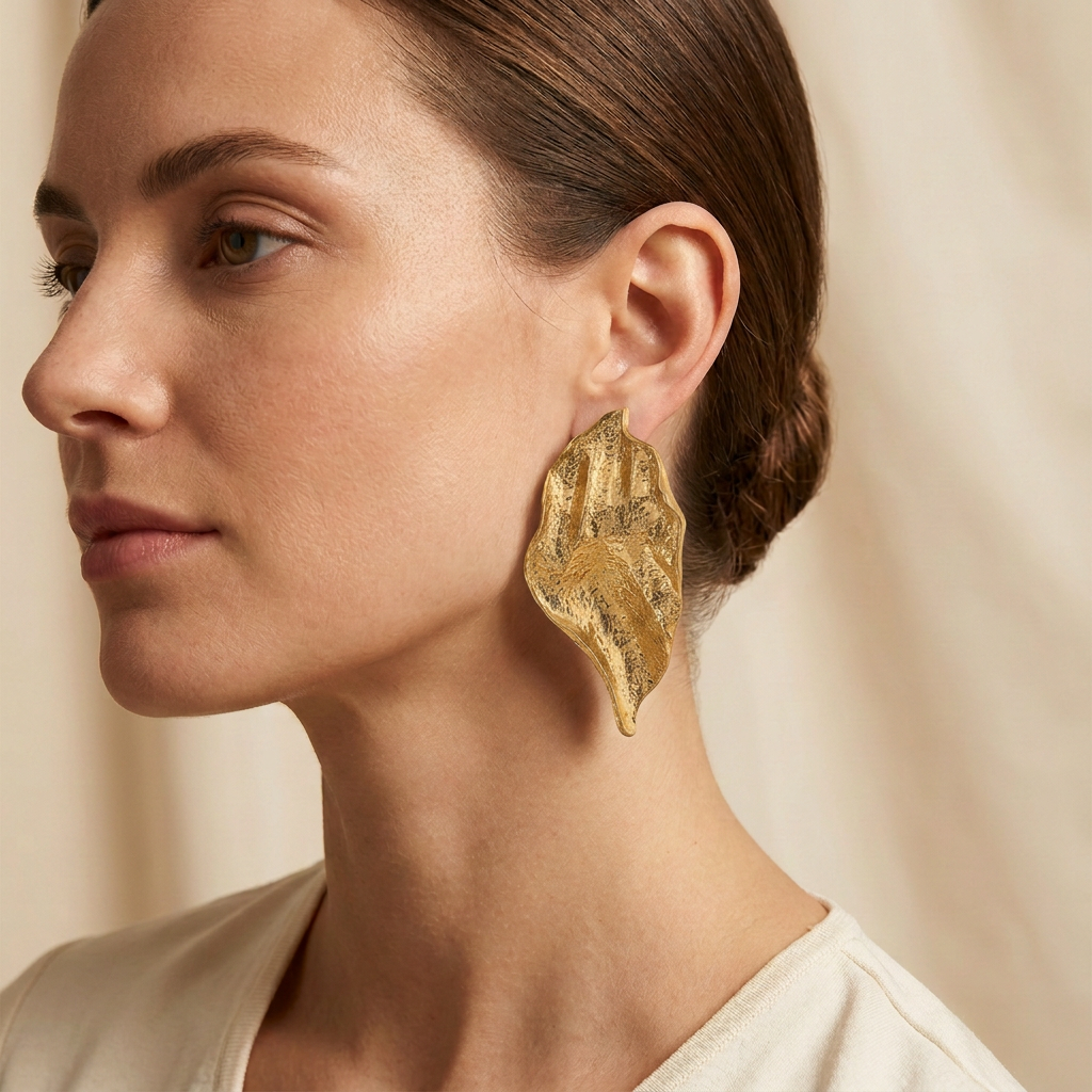 Corrected gold Molten Petal earring on a model