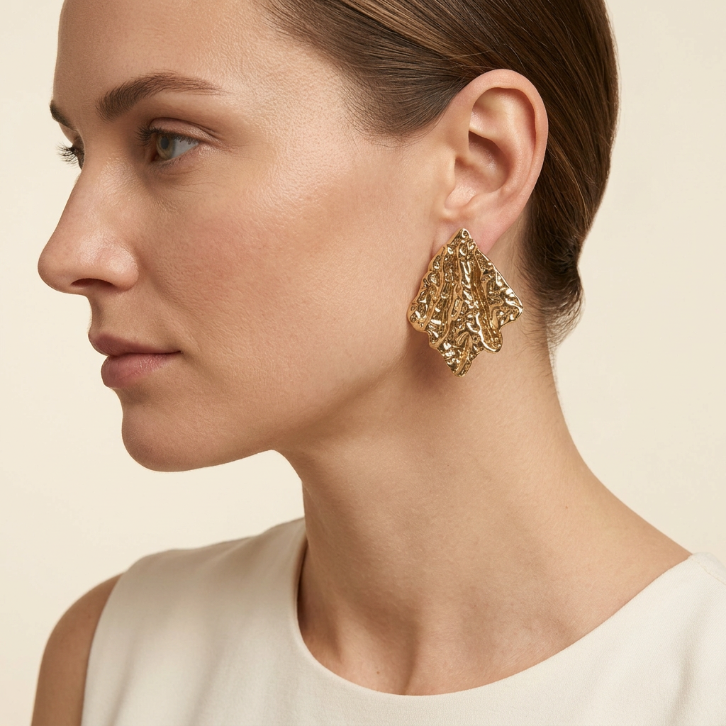 AI-generated model wearing a gold-tone sculpted leaf earring