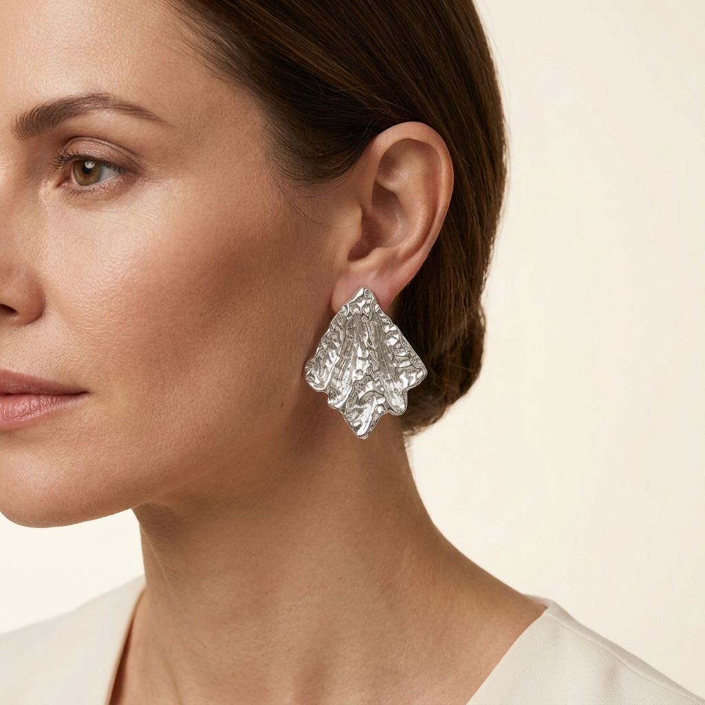 AI-generated model wearing a silver-tone sculpted leaf earring
