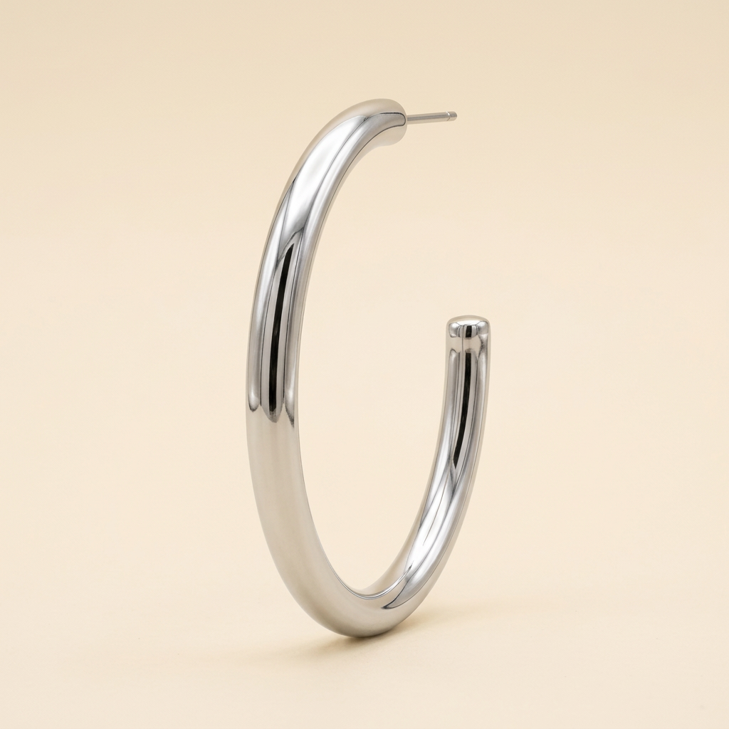 Silver-tone polished stainless steel open hoop earring on an ivory background