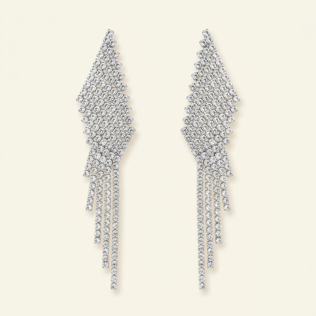 Silver-tone Celeste Cascade earrings with diagonal clear stones and cascading fringe on an ivory background